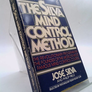 May include: A blue book with gold lettering titled "The Silva Mind Control Method" by José Silva and Philip Miele. The book is selected by Psychology Today Book Club.