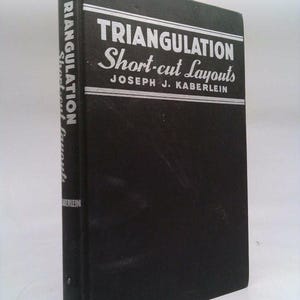 May include: A black book with the title "Triangulation Short-cut Layouts" by Joseph J. Kaberlein.