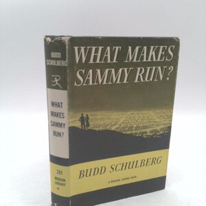 May include: A vintage hardcover book titled "What Makes Sammy Run?" by Budd Schulberg. The book has a dark green and black cover with white lettering and a yellow spine. The cover features an illustration of two figures against a landscape.