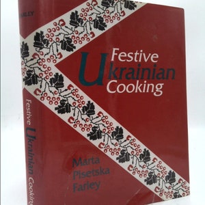 May include: A red book with a white and black patterned design on the cover. The title is "Festive Ukrainian Cooking" by Marta Pietska Farley.