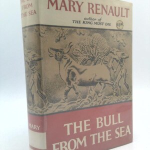 May include: A hardcover book titled "The Bull From The Sea" by Mary Renault. The cover features a sepia-toned illustration of a bull and figures, with the title in white and the author's name in red.