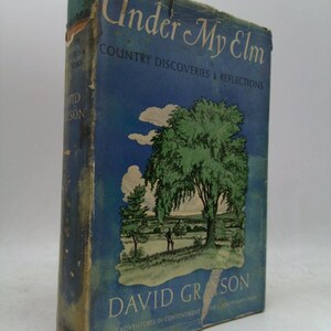 May include: A vintage book titled "Under My Elm" with a blue cover featuring a tree illustration. The book's cover also displays the author's name, David Grayson, and the subtitle "Country Discoveries & Reflections."