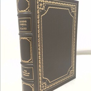 May include: A brown leather-bound book with gold lettering on the spine. The title is "Eugene O'Neill Plays" and the book is part of "The Franklin Library".