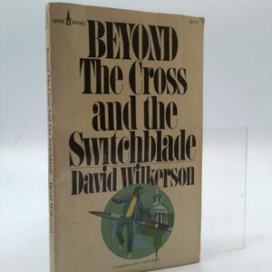 May include: A vintage paperback book titled "Beyond The Cross and the Switchblade" by David Wilkerson. The cover is tan with bold black lettering and a circular illustration of a man and a church. The book is a Spire Books edition.