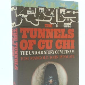 May include: A hardcover book titled "The Tunnels of Cu Chi: The Untold Story of Vietnam" with a dark cover featuring a tunnel entrance and a soldier. The title is in large red letters.