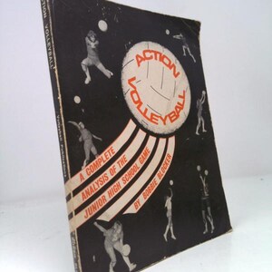 May include: Vintage book cover for "Action Volleyball" by Bobbie Blocker. The cover is black with illustrations of volleyball players and a large volleyball graphic. Text includes "A Complete Analysis of the Junior High School Game."