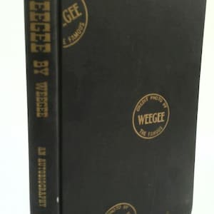 May include: A white ceramic mug with a black handle and the text "But First, Coffee" in a black, handwritten-style font. The mug is on a white surface.