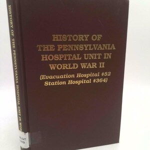 May include: A hardcover book with a dark brown cover. The title "HISTORY OF THE PENNSYLVANIA HOSPITAL UNIT IN WORLD WAR II" is printed in gold lettering. The spine reads "HISTORY OF THE PENNSYLVANIA HOSPITAL UNIT IN WOR".