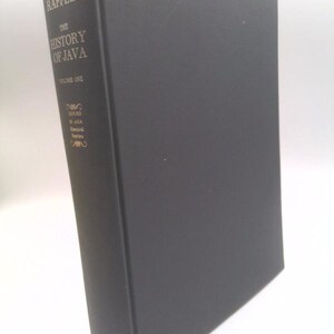 May include: A black hardcover book titled The History of Java Volume One by Thomas Stamford Raffles. The spine features gold lettering and the Oxford logo at the bottom. The book is presented in a vertical standing position with a clean cover.