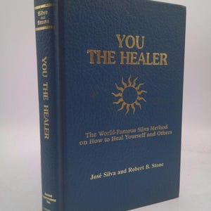 May include: A hardcover book titled "YOU THE HEALER" with gold lettering on a blue cover. The book's spine also features the title. The cover includes a sunburst design and the authors' names, José Silva and Robert B. Stone.