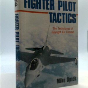 May include: A book titled "Fighter Pilot Tactics: The Techniques of Daylight Air Combat" by Mike Spick. The cover features a gray fighter jet against a blue sky.