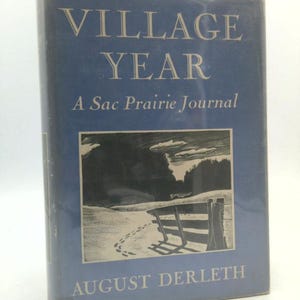 May include: A hardcover book titled "Village Year: A Sac Prairie Journal" by August Derleth. The book has a blue cover with white lettering and a black and white illustration of a winter landscape.