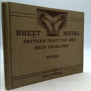 May include: A tan book with the title "Sheet Metal Pattern Drafting and Shop Problems" by Daugherty and Powell. The book is revised and has a brown illustration of two metal pipes on the cover.
