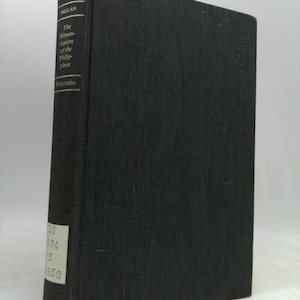 May include: A hardcover book with a dark gray cover. The spine features the title "The Hispanization of the Philippines" and the author's name, "Phelan." The book is from Wisconsin, with the year 1959 visible.