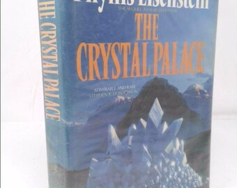 May include: A book cover with a blue background and a white crystal palace. The title of the book is "The Crystal Palace" by Phyllis Eisenstein. The subtitle is "The Sequel to "The Sorcerer's Son."