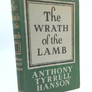 May include: A vintage hardcover book titled "The Wrath of the Lamb" by Anthony Tyrrell Hanson. The book has a green cover with white lettering and a rectangular border. The spine also features the title and author's name.