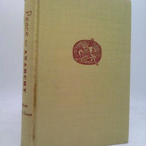 May include: A hardcover book titled "Peace or Anarchy" by Meyer. The book has a light tan cover with a red illustration of two figures and a trident. The spine displays the title vertically.
