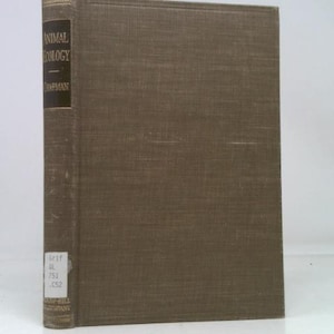 May include: A hardcover book titled "Animal Ecology" by Chapman. The book has a brown cover with the title and author's name printed on a dark panel on the spine. The book is standing upright.
