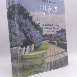 May include: A book cover with a watercolor illustration of a country road lined with lilac bushes. The title of the book is "Lilacs and Limestone: An Illustrated History of Pittsburgh Township 1787-1987" by William J. Patterson.
