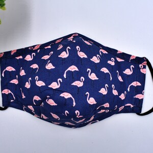 May include: A blue face mask with a pink flamingo pattern.