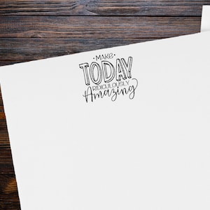 May include: White card with black text that reads "Make Today Ridiculously Amazing."