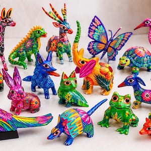May include: A collection of fifteen hand-painted wooden animal figurines, including a giraffe, lizard, deer, butterfly, flamingo, bull, rabbit, fox, elephant, turtle, bird, armadillo, frog, dachshund, and hedgehog, all featuring vibrant, multi-colored patterns.