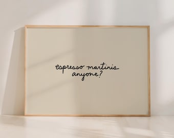 May include: A framed print with the text "espresso martinis anyone?" in black script on a beige background. The frame is a light wood color, and the print is displayed against a white wall.