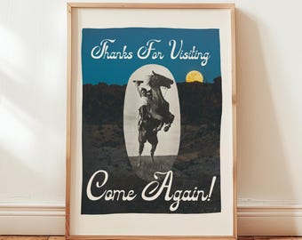 May include: Framed vintage-style poster featuring a cowboy on a rearing horse against a night sky with a full moon. The poster includes the text "Thanks For Visiting" and "Come Again!" in a decorative font, set within a wooden frame.