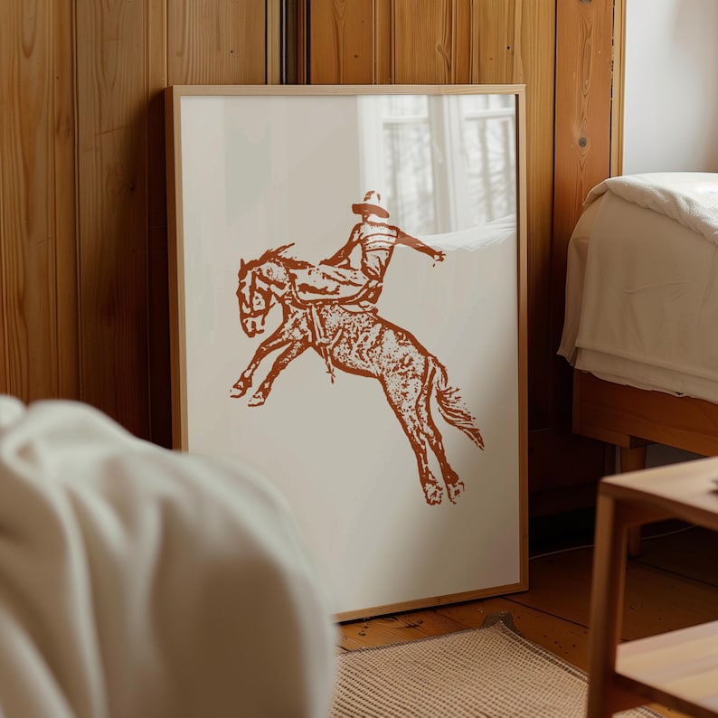 May include: A brown silhouette of a cowboy riding a bucking horse. The image is on a white background.