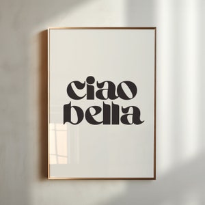 May include: A framed print with the text "ciao bella" in a bold, black font on a white background.