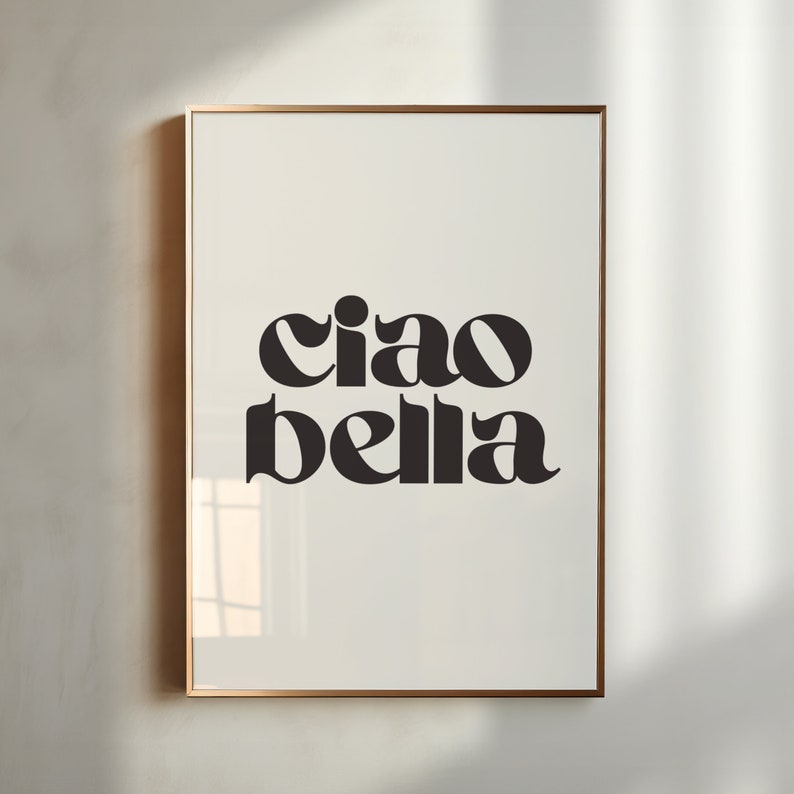 May include: A framed print with the text "ciao bella" in a bold, black font on a white background.