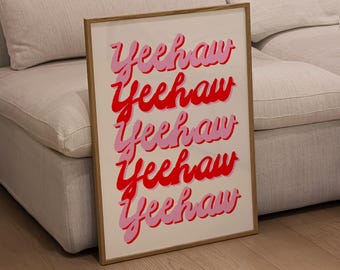 May include: A framed print with the word "Yeehaw" repeated five times in a pink and red font. The print is on a white background and has a wooden frame.