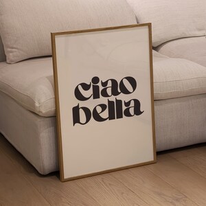 May include: A framed print with a white background and black text that reads "ciao bella".