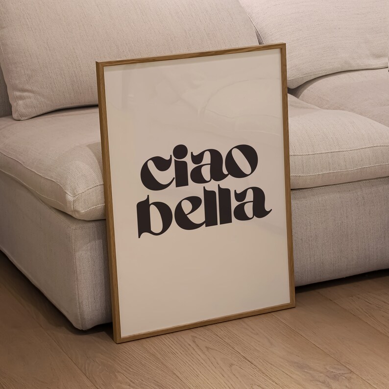 May include: A framed print with a white background and black text that reads "ciao bella".