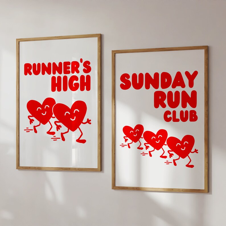 May include: Two framed prints with red heart illustrations. The left print says "Runner's High" and features three red hearts with legs and arms. The right print says "Sunday Run Club" and features four red hearts with legs and arms.