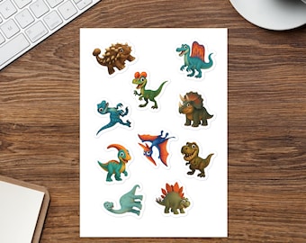 May include: A sheet of colourful dinosaur stickers. The stickers feature various cartoon dinosaurs in shades of green, blue, brown, and orange. The dinosaurs have different shapes and sizes, with some having spikes, horns, and wings. The stickers are on a white background.