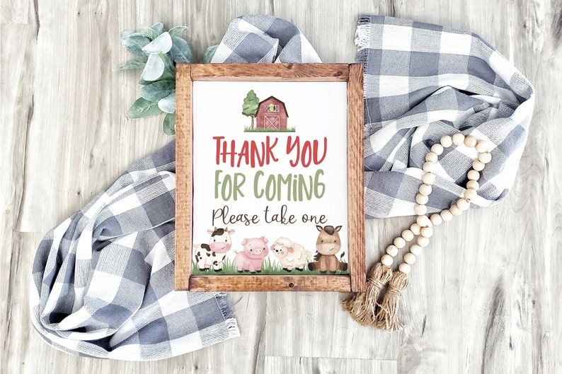 May include: A framed sign with a red barn and farm animals, saying "Thank You For Coming. Please take one."