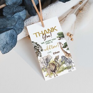 May include: Thank you card with a watercolor illustration of a jungle scene with animals like a giraffe, zebra, lion, elephant, and leopard. The text on the card reads "Thank You! We hope you had a wild time! Love, Ethan".