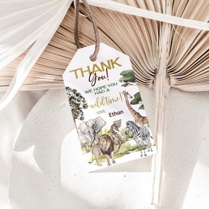 May include: Thank You! We hope you had a wild time! Love, Ethan. A white thank you tag with gold lettering and a jungle animal illustration.