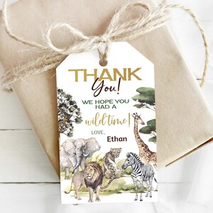 May include: Thank you! We hope you had a wild time! Love, Ethan. A white thank you tag with a gold and brown jungle animal theme. The tag features a giraffe, zebra, lion, elephant, and leopard.