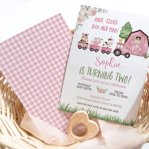 May include: Pink and green farm-themed birthday invitation with a red barn, animals, and a train. The invitation says "Sophia is turning two!" and includes the date, time, and location of the party. RSVP by November 15th.