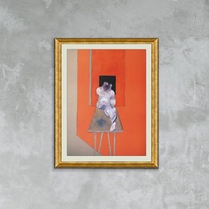 May include: A framed painting depicting a nude figure seated on a wooden platform within a room featuring a red wall. The figure is positioned with their back to the viewer and the wall. The painting is presented in a gold frame.