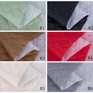 May include: Six samples of quilted fabric in different colors. The fabric is folded in half, showing the quilted pattern and the white backing. The colors are: green, black, brown, red, white, and gray. Each sample is labeled with a number from 1 to 6.