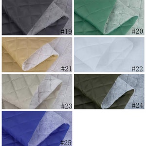 May include: Six different colors of quilted fabric swatches. The swatches are arranged in two rows of three. The colors are black, green, beige, white, olive green, and blue. Each swatch has a number printed on it, from 19 to 25.