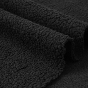 May include: Close-up of black fleece fabric with a textured surface.