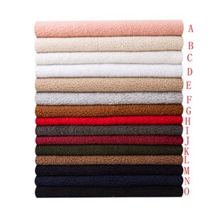 May include: A stack of 15 fabric swatches in various colors, including pink, beige, white, gray, brown, red, burgundy, green, and blue. The swatches are arranged in a vertical stack, with the top swatch being pink and the bottom swatch being blue.