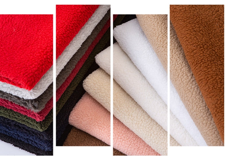 May include: A variety of plush fabrics in different colors, including red, white, brown, and beige. The fabrics are stacked in piles and have a soft, fuzzy texture.