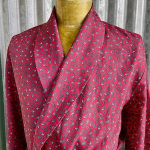 May include: A red paisley patterned robe with a shawl collar.