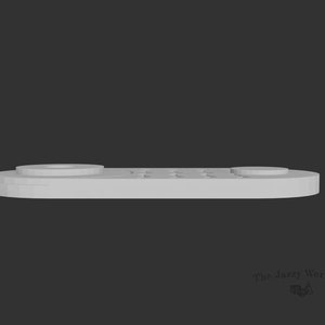 May include: A white plastic remote control with a circular button on the left side and a row of rectangular buttons on the right side.