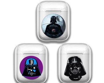 May include: Three white Airpod cases with different Darth Vader designs. The first case has a design of Darth Vader standing in front of the Death Star. The second case has a design of Darth Vader's head with a purple background. The third case has a design of Darth Vader's head with a white background.